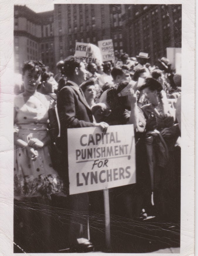 a black and white photo featuring protestors and signs