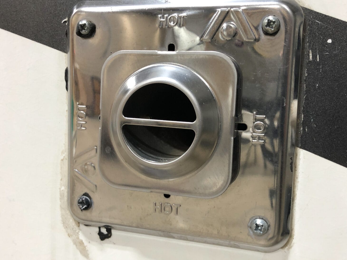 Silver furnace intake exhaust vent on the exterior of an RV