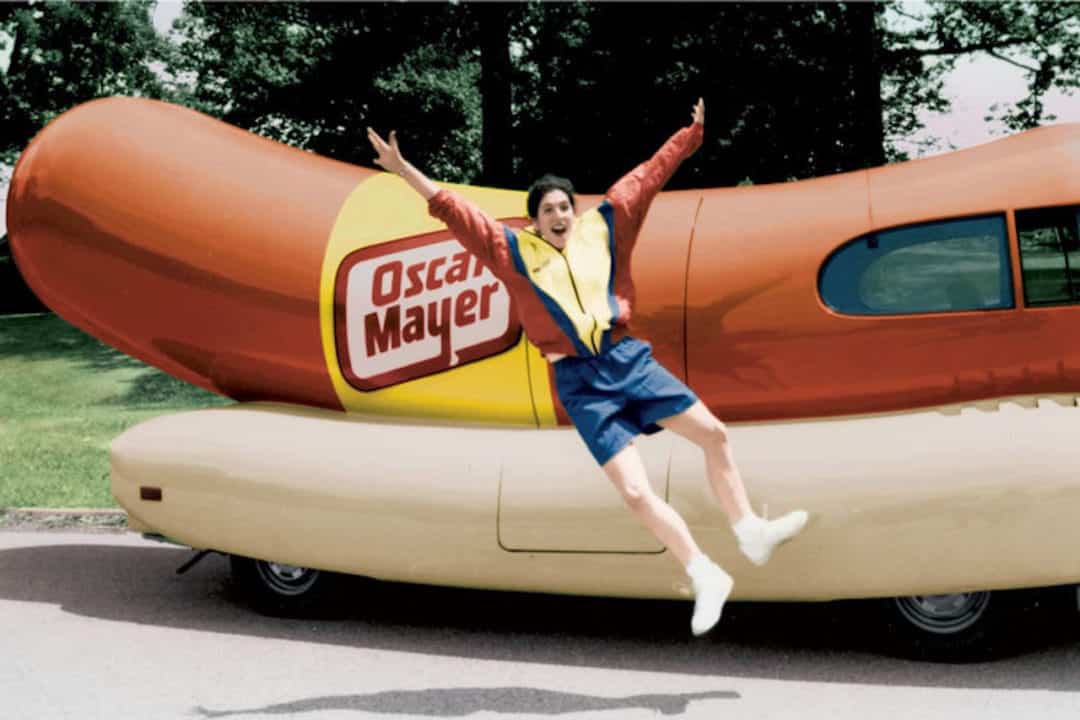 Robin Gelfenbien clicks heels in front of wienermobile