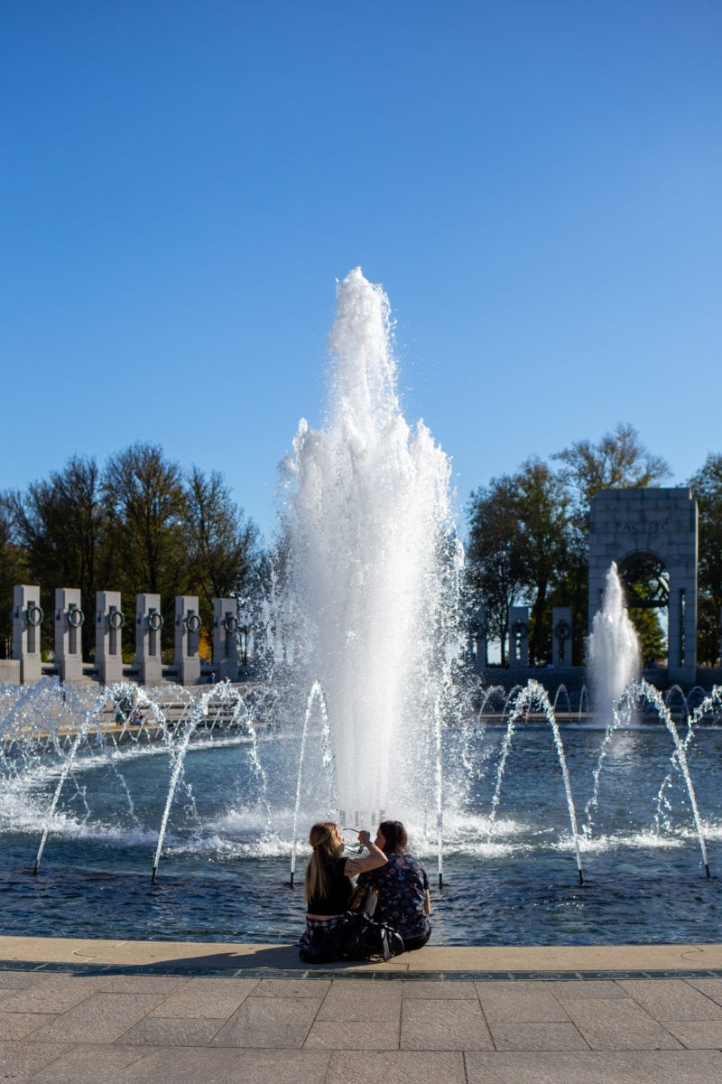 Visitors are encouraged to stick their feet into the water at the World War II Memorial, reminiscent of the ways members of the Armed Forces celebrated the end of the war in Europe.
