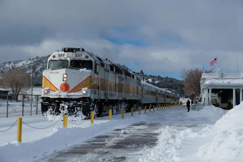 A train rests on tracks covered in snowy white