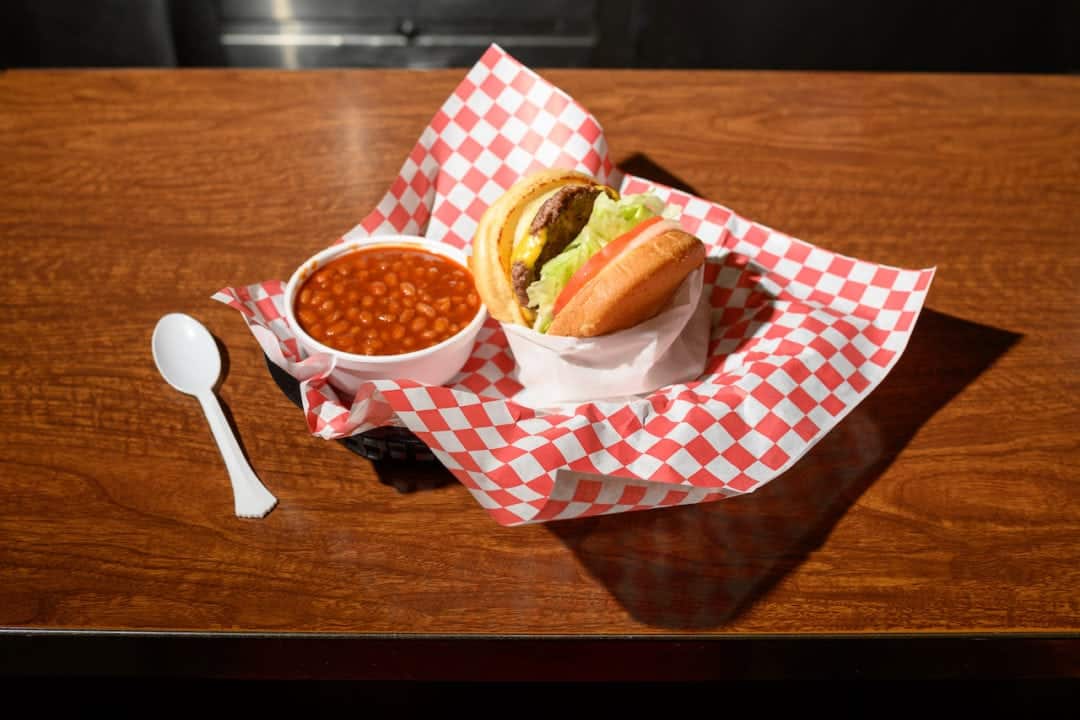 A hand-pressed burger with a side of beans at woolworth's diner